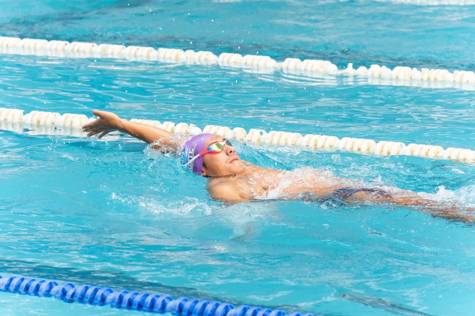 Man Relaxing in Swimming Pool